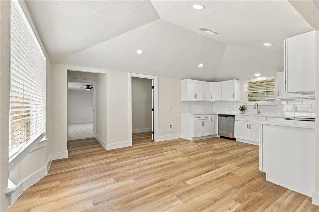 Recessed lighting, ceiling fan, carpeting, two windows with blinds, and a paneled door