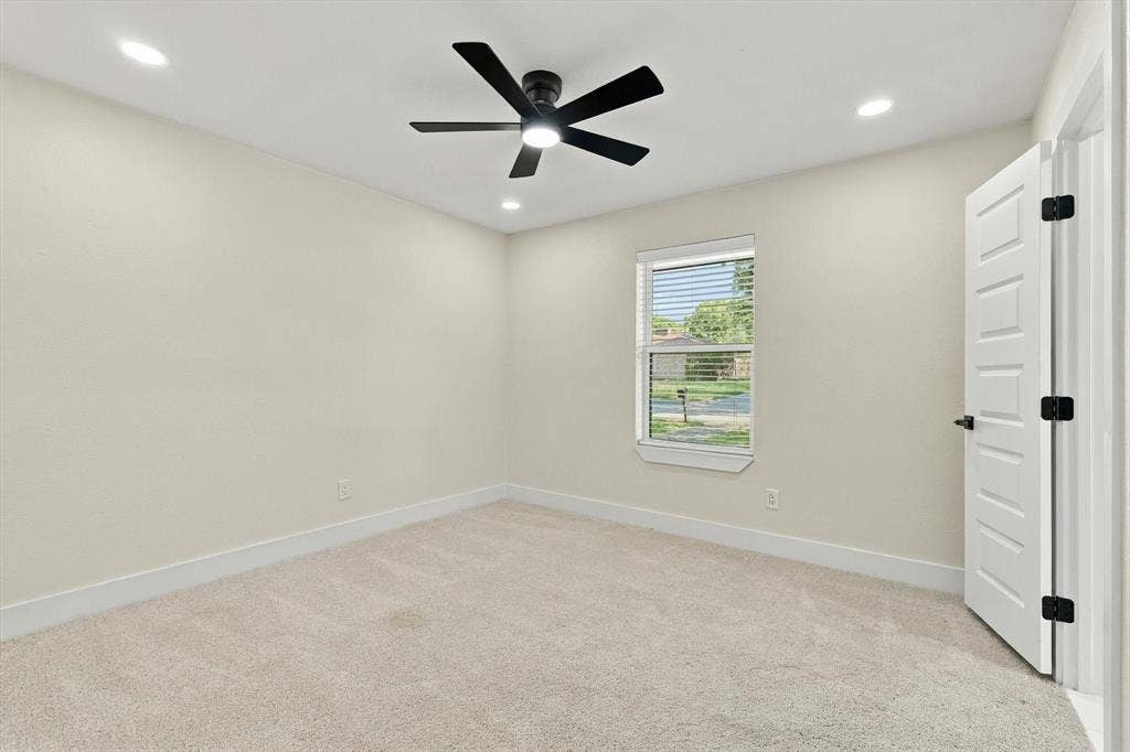 Soft neutral carpet flooring, recessed lighting, and a contemporary ceiling fan