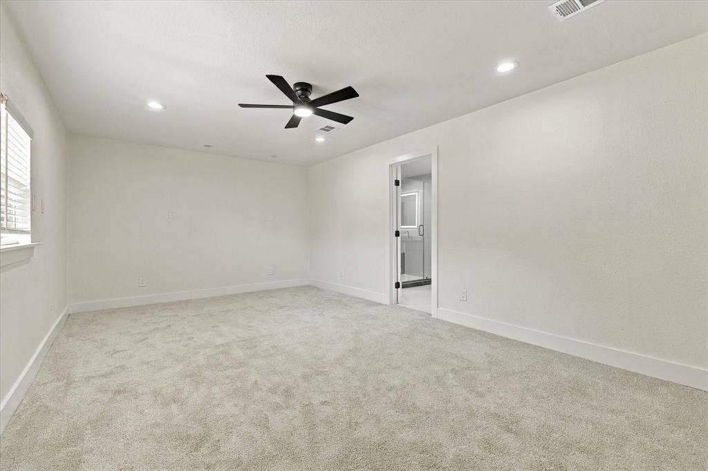 Recessed lighting, ceiling fan, and light gray carpeting