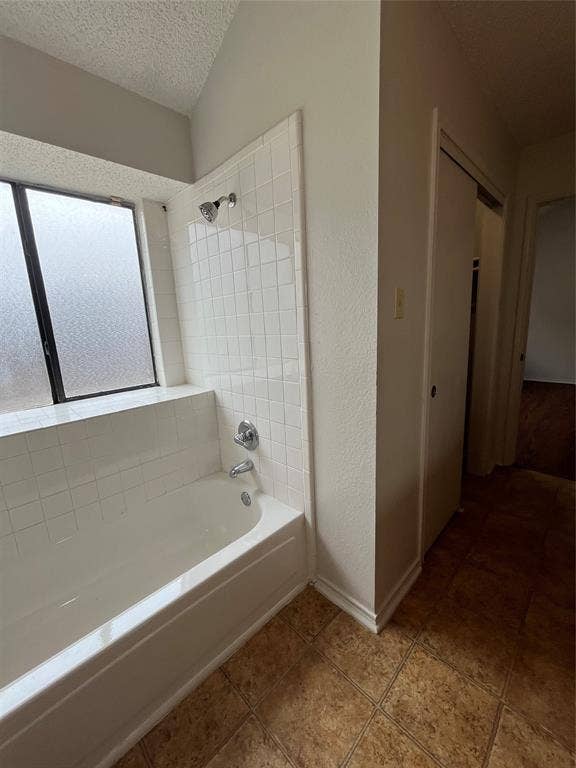 724 Ballard Street, Cedar Hill, TX 75104 Bathroom with tile patterned floors, tiled shower / bath combo, and a textured ceiling