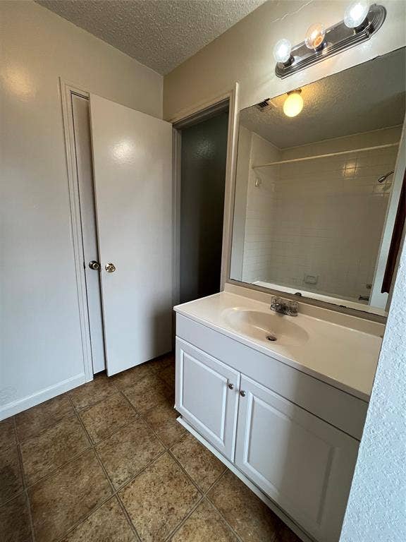 724 Ballard Street, Cedar Hill, TX 75104 Bathroom featuring vanity, a textured ceiling, and tile patterned flooring