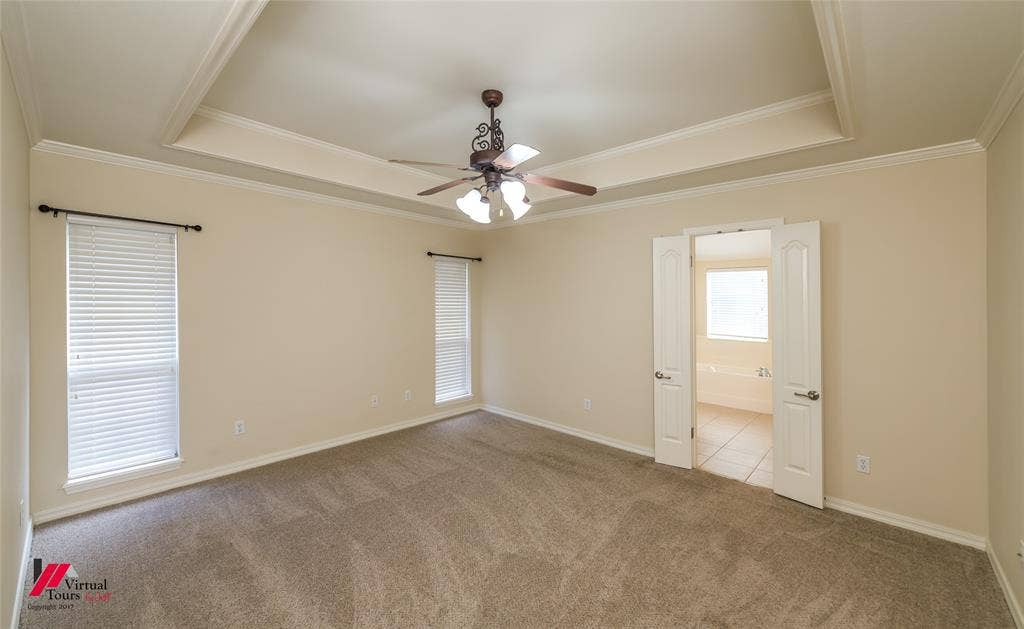 Tray ceiling, wall-to-wall carpeting, ceiling fan with integrated lighting, dual-casement windows, and double-door entry