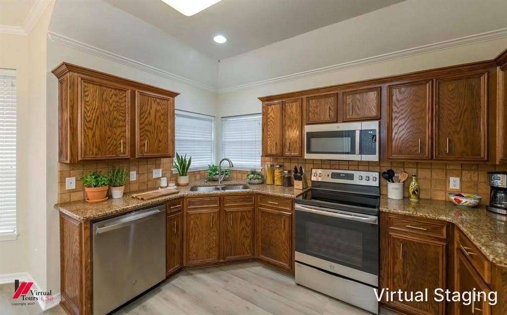 Virtually staged. Kitchen featuring stained wood cabinetry, stone-surface countertops, tile backsplash, and stainless steel appliances