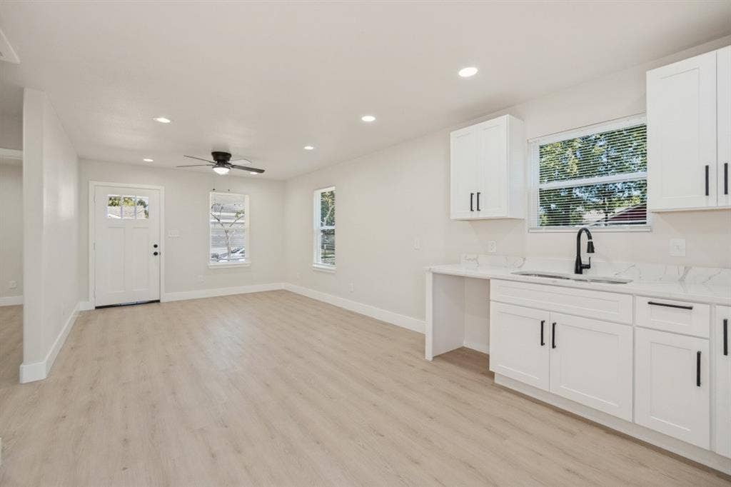 Light wood-finish flooring complements the bright interior