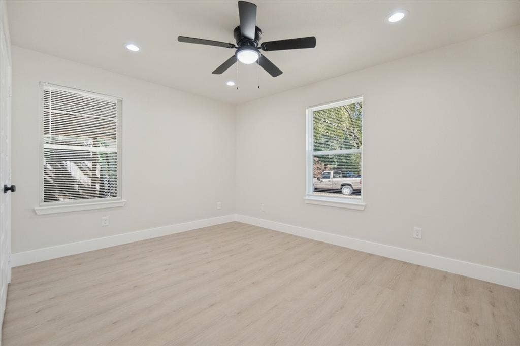 Recessed lighting, wood-finish flooring, and a ceiling fan with integrated lighting