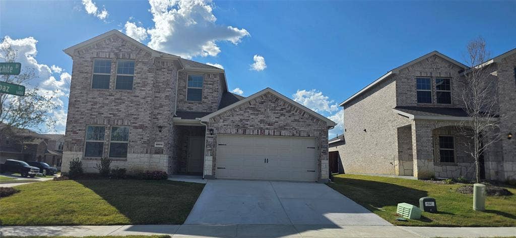 3904 Malachite Drive, Celina, TX 75009 Two-story exterior with brick and stone accents, attached garage, and well-maintained front lawn