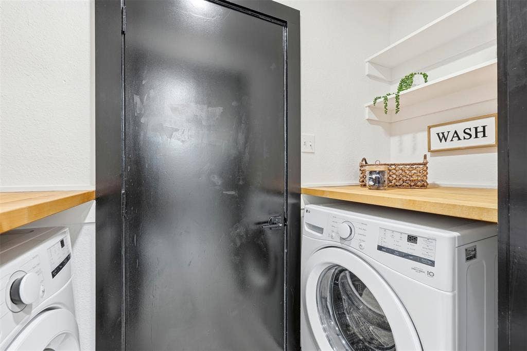 Built-in wood-finish countertop, front-load washing machine, and two floating shelves