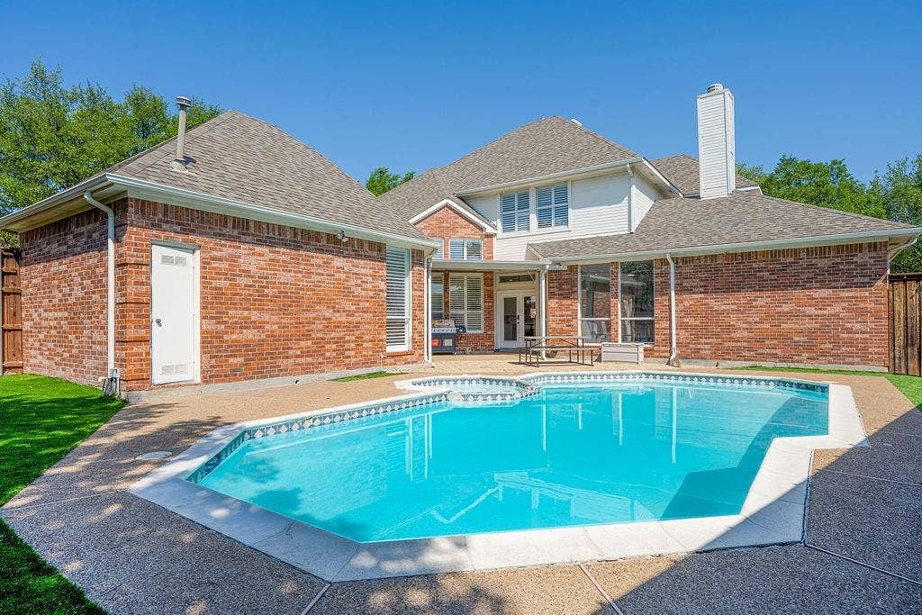 2007 Hill Haven Circle, Richardson, TX 75081 Outdoor swimming pool, brick exterior, multi-story structure, ample patio space, and a white chimney