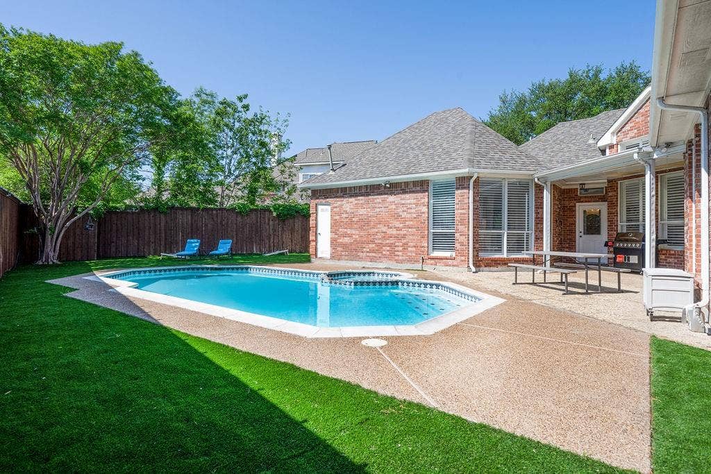 2007 Hill Haven Circle, Richardson, TX 75081 In-ground swimming pool with a textured concrete deck and surrounding artificial turf