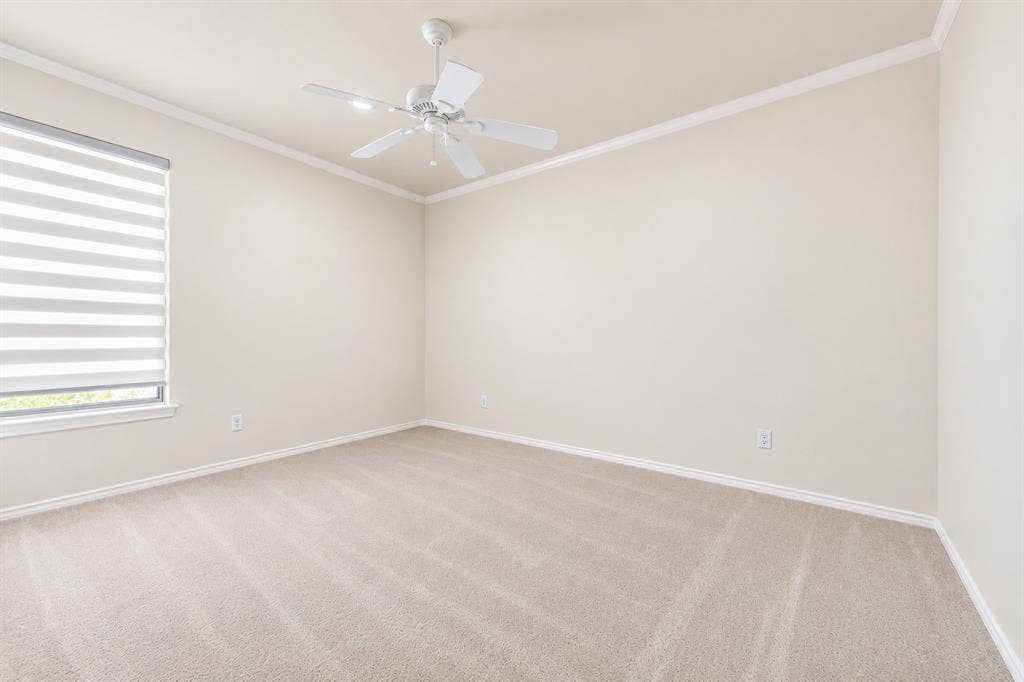 4612 Saxon Drive, Plano, TX 75093 Recessed window with horizontal blinds, ceiling fan, crown molding, and neutral-toned carpet flooring