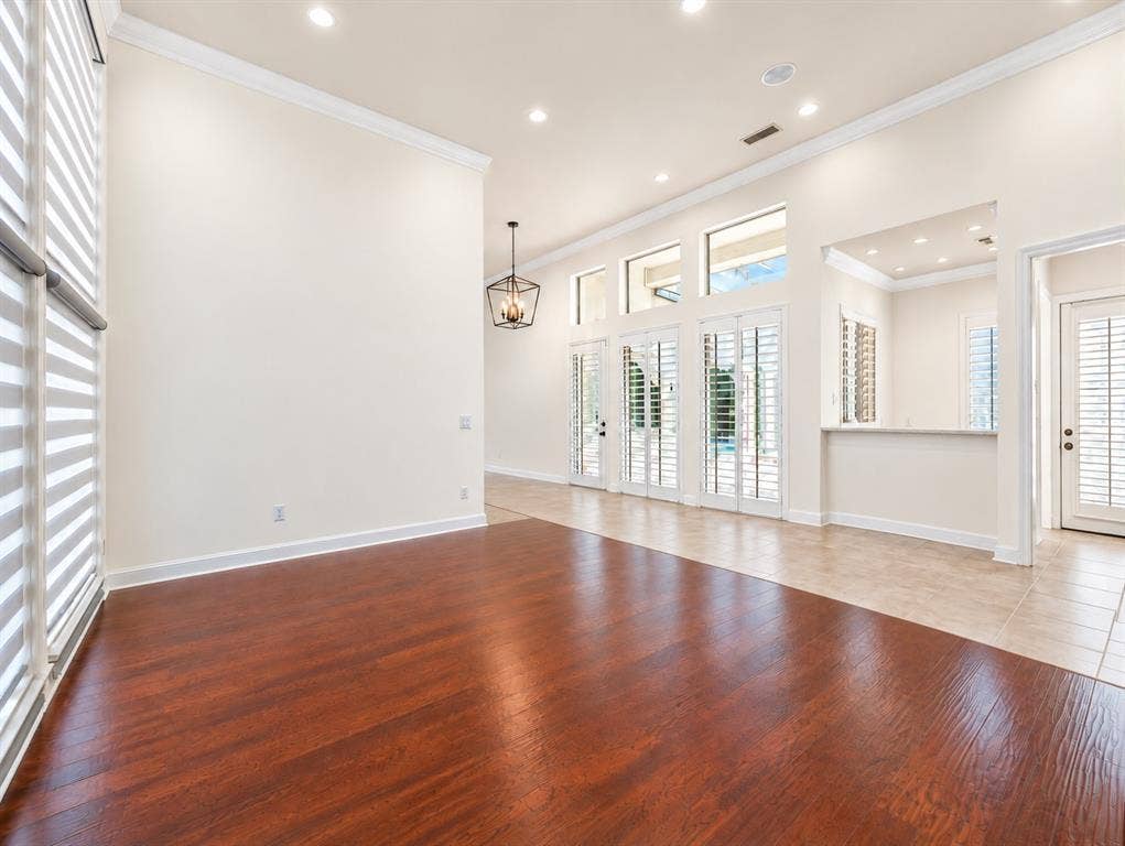 4612 Saxon Drive, Plano, TX 75093 High ceilings with recessed lighting, wood-finish flooring, plantation shutters, transom windows, and a built-in bar