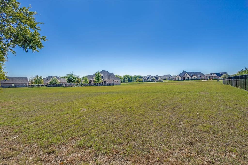 C-14 Waterstone Estates, McKinney, TX 75071 Expansive grassy lot with a black metal fence border