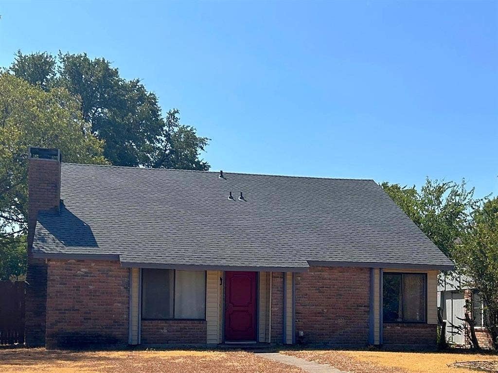 2926 Bonanza Lane, Garland, TX 75042 Brick facade with a contrasting red entry door