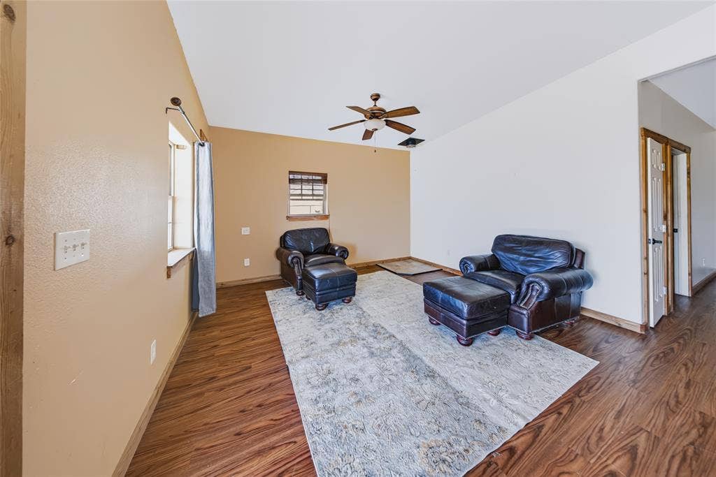 560 Green Acres Road, Weatherford, TX 76088 Vaulted ceiling with a ceiling fan, wood-finish flooring, and natural wood trim accents