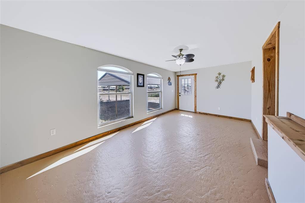560 Green Acres Road, Weatherford, TX 76088 Second Home – door frames, textured concrete flooring, and a ceiling fan with light fixture