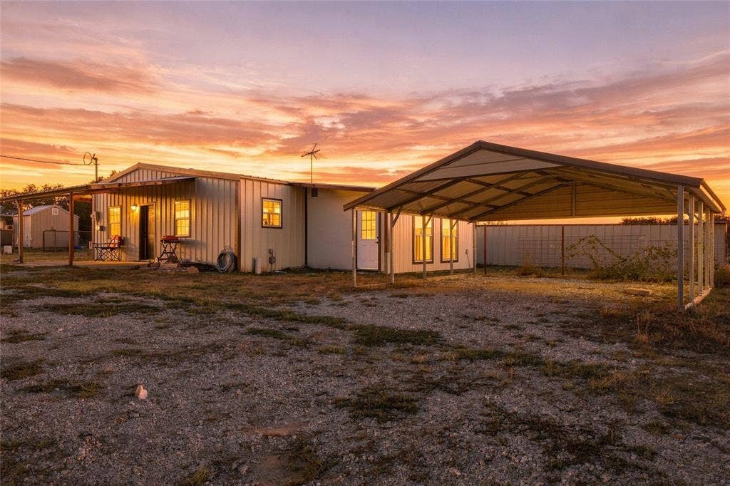 560 Green Acres Road, Weatherford, TX 76088 Second Home – Metal-sided structure with a covered porch, an attached carport, and a partially fenced perimeter