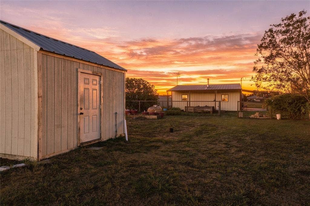 560 Green Acres Road, Weatherford, TX 76088 Metal-roofed outbuilding with a four-panel door
