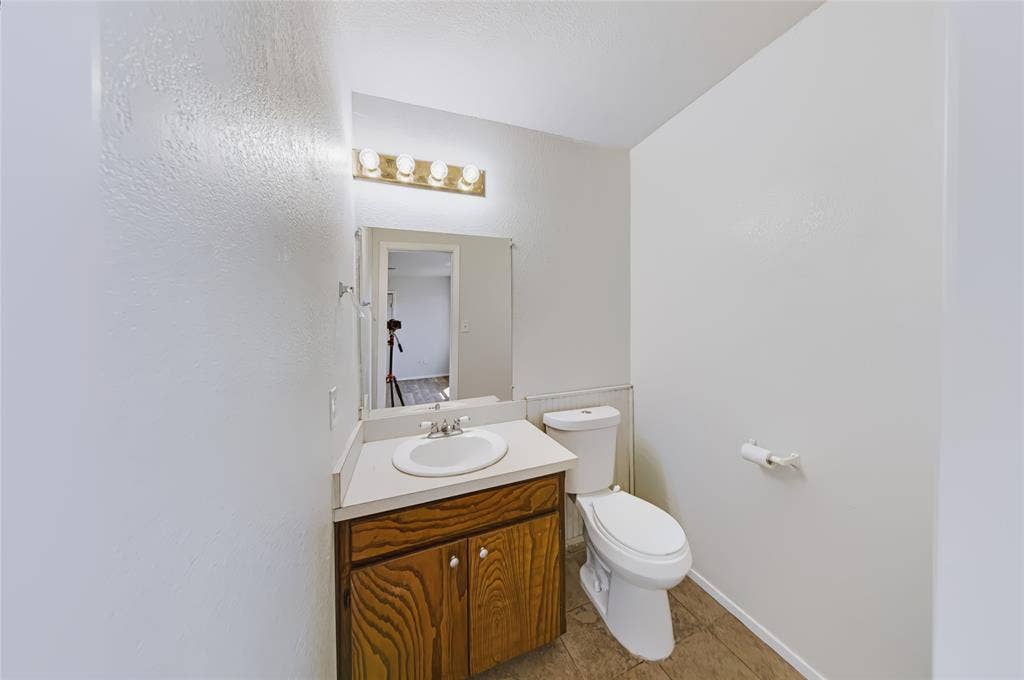 560 Green Acres Road, Weatherford, TX 76088 Vanity with wood-finish cabinetry and integrated sink