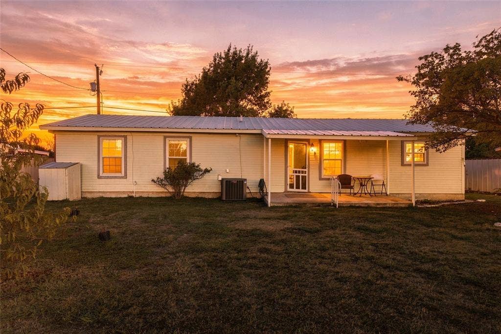 560 Green Acres Road, Weatherford, TX 76088 Single-story residence featuring light-colored siding, a metal roof, and a covered front porch