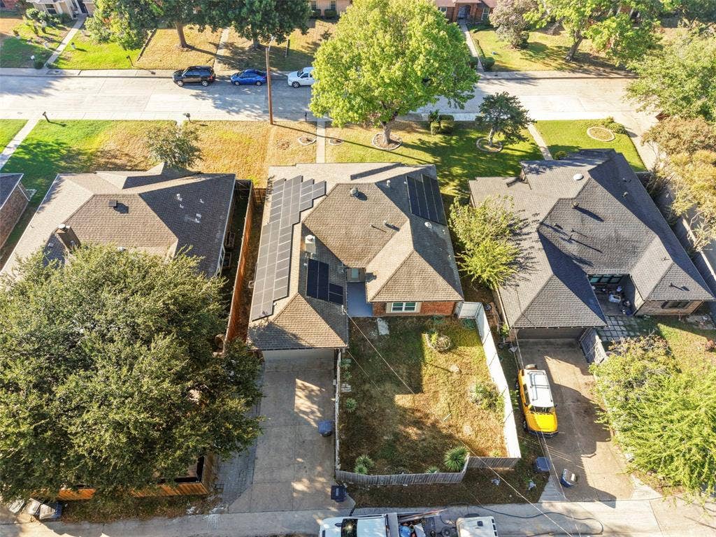 Residential property featuring a pitched roof, attached garage, and a concrete driveway