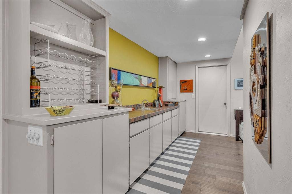 Wet Bar with an abundance of storage. Doorway to 2 car garage.