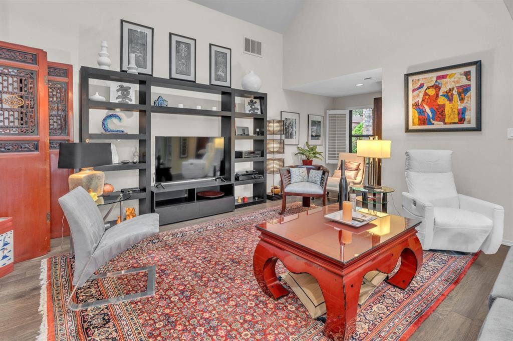Living area with wood flooring and separate reading area