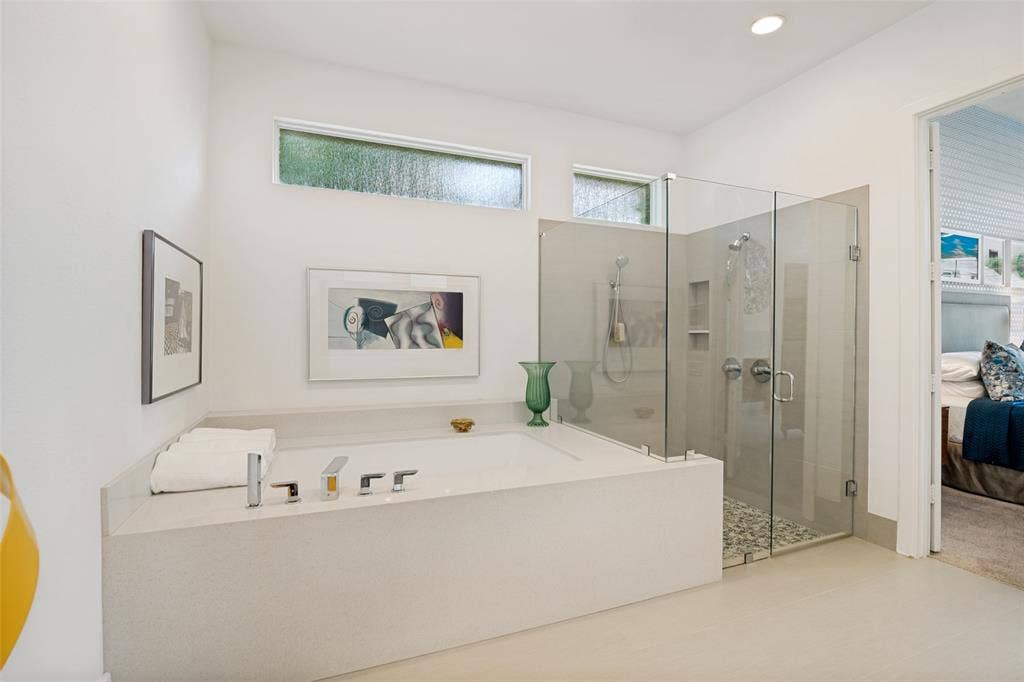5904 Kensington Drive, Plano, TX 75093 Large soaking tub with room for bath items and glass surround shower.