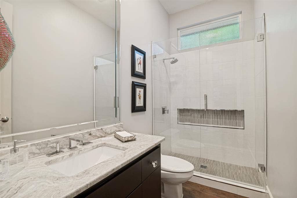 5904 Kensington Drive, Plano, TX 75093 This updated full bath is just a few steps from the fourth bedroom (current study) downstairs.