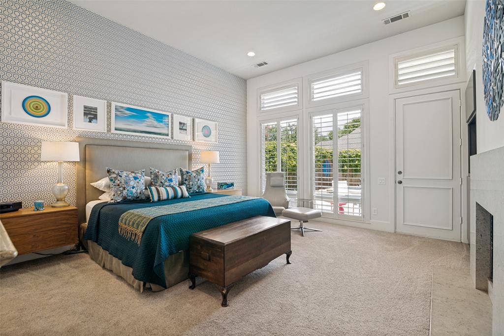 5904 Kensington Drive, Plano, TX 75093 Natural light from oversize windows and access to the patio and pool. Floating nightstands are a sophisticated design touch.