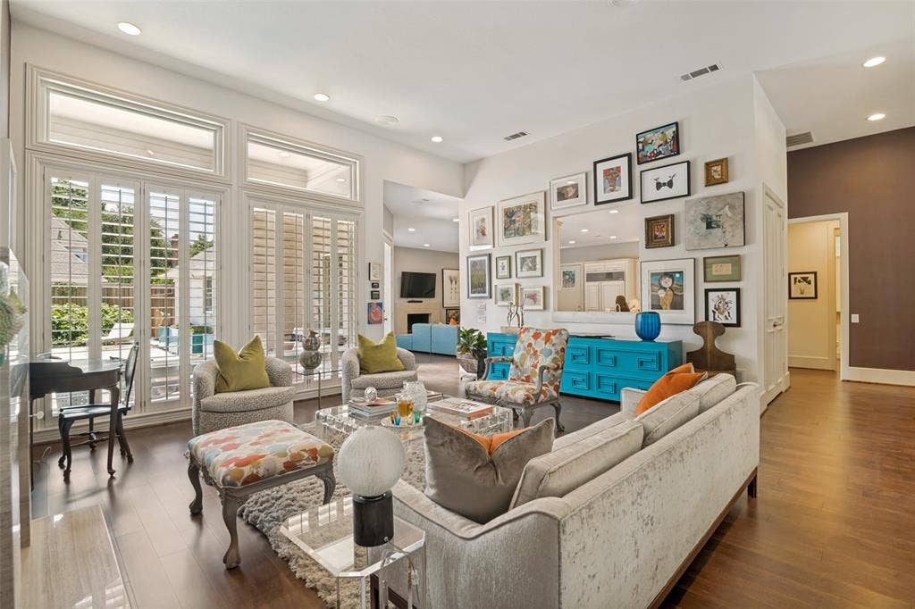 5904 Kensington Drive, Plano, TX 75093 View of the living room from the front entry is a showstopper! Walls of windows with pool/patio views and abundant natural light wrap around to the family room! 12 foot ceilings!
