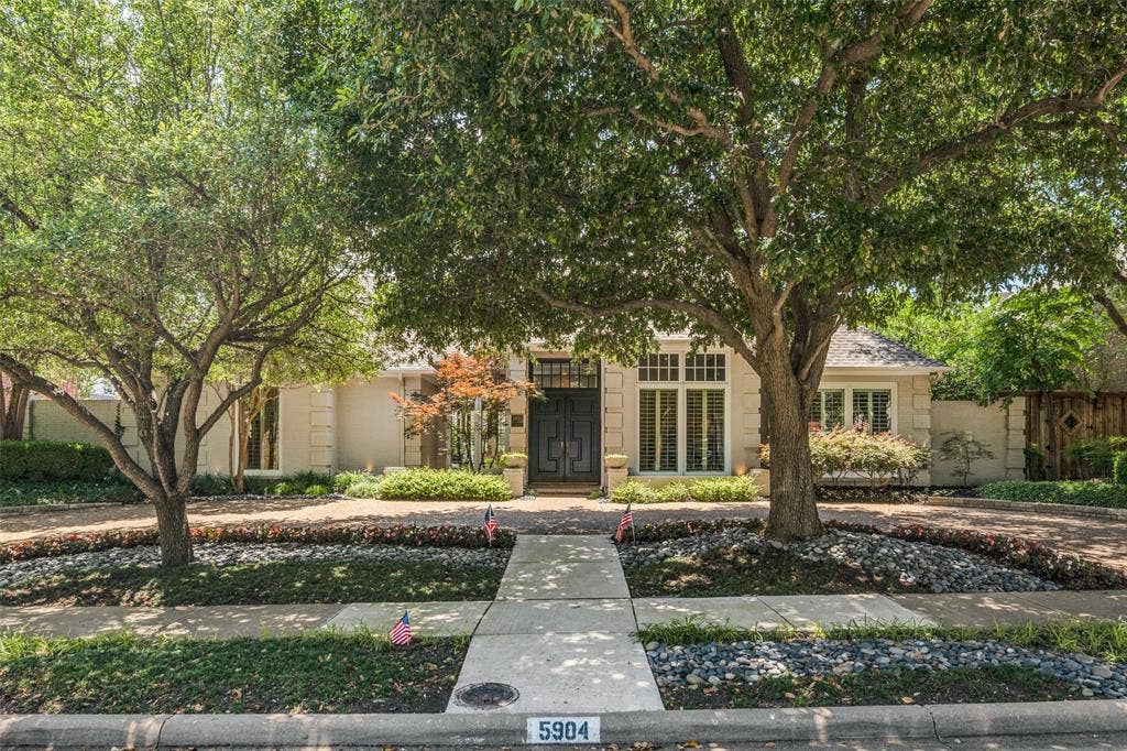 5904 Kensington Drive, Plano, TX 75093 Tall trees frame the driveway for classic, inviting curb appeal.