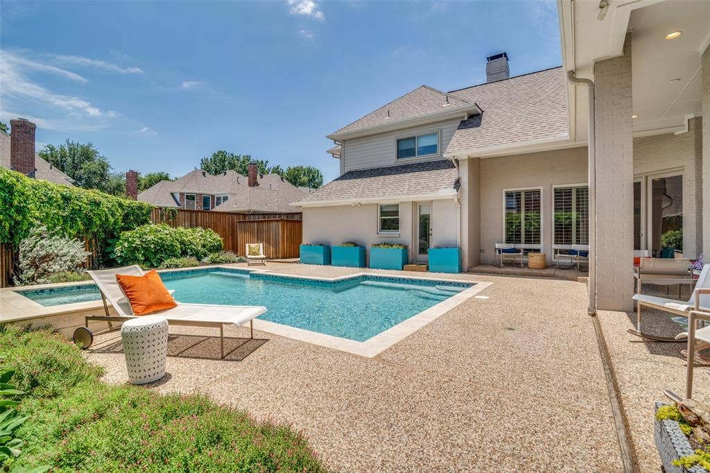 5904 Kensington Drive, Plano, TX 75093 Beautiful blooms along the fence line and greenery surround the pool