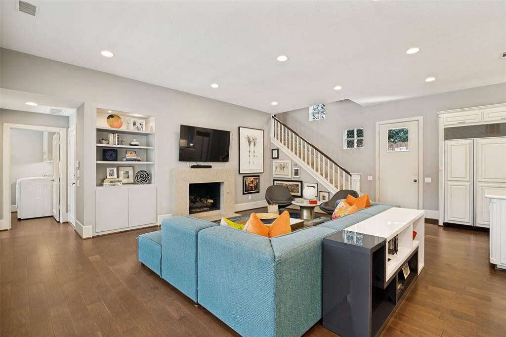 5904 Kensington Drive, Plano, TX 75093 Casual and comfortable family room is a seamless, colorful extension of the kitchen! Second of the three fireplaces remodeled. The door on the right leads to a turfed side yard, perfect for pets