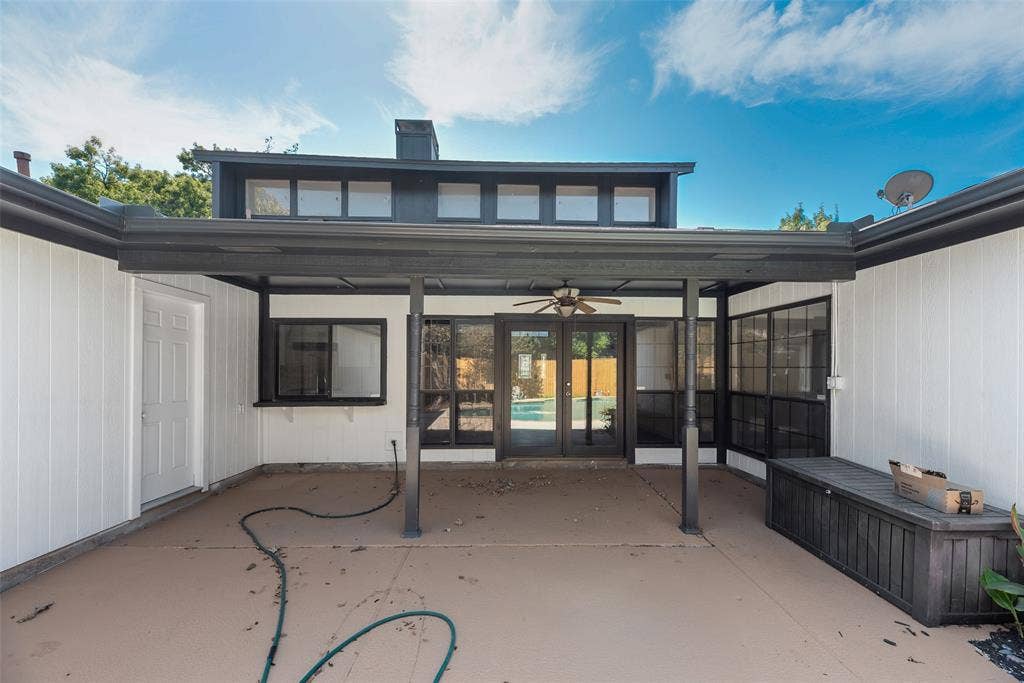 1903 Clemson Drive, Richardson, TX 75081 Exterior patio featuring a covered area with a ceiling fan, multiple windows, and a white paneled door