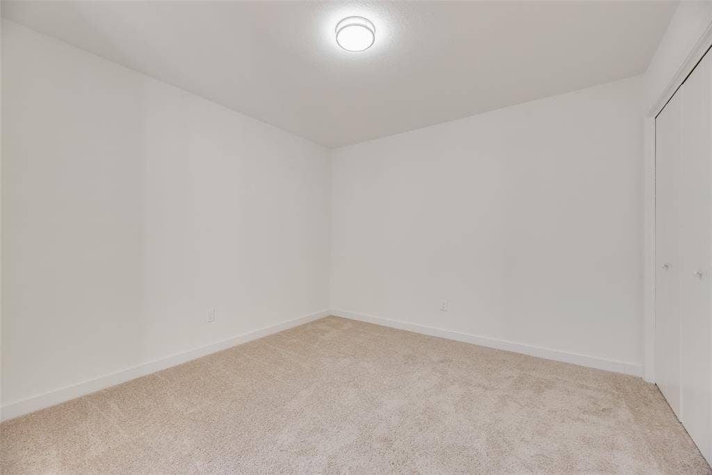 1903 Clemson Drive, Richardson, TX 75081 Neutral-toned carpeting, white walls, and a flush-mount ceiling light