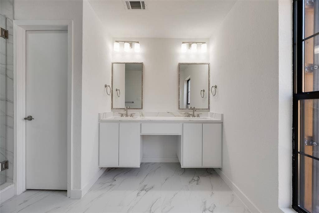 1903 Clemson Drive, Richardson, TX 75081 Dual floating vanities with undermount sinks and light-colored countertops