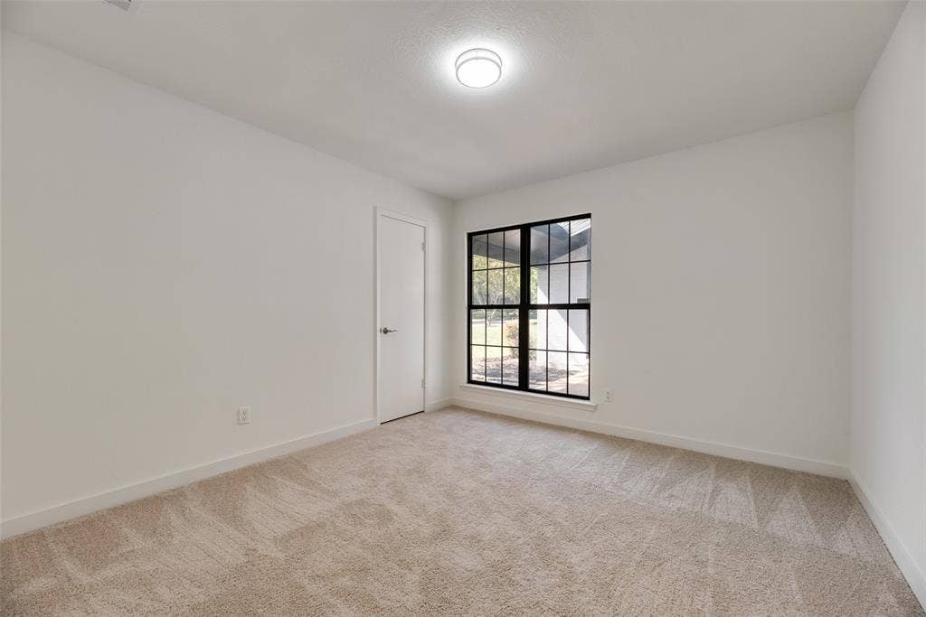 1903 Clemson Drive, Richardson, TX 75081 Light-colored carpeting with a textured pattern