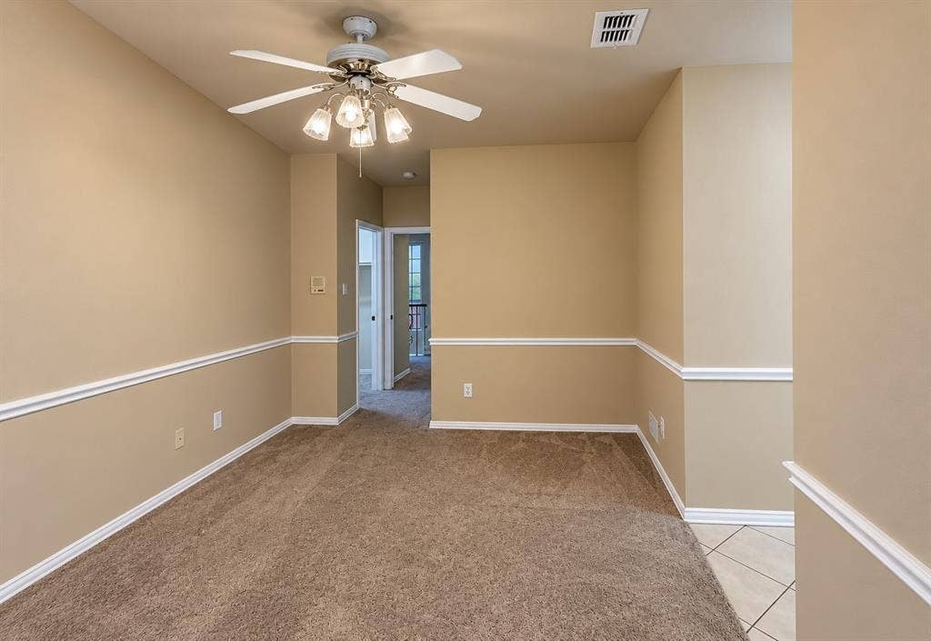 4505 Southgate Drive, Plano, TX 75024 Carpeted room featuring a ceiling fan with integrated lighting, chair rail molding, and a neutral color palette