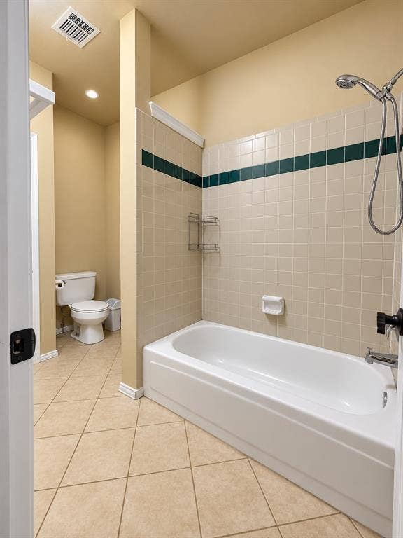 4505 Southgate Drive, Plano, TX 75024 Tile flooring with a matching tiled shower surround, featuring a dark accent band