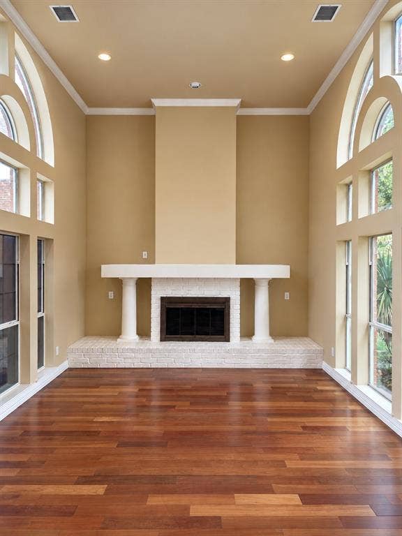 4505 Southgate Drive, Plano, TX 75024 Hardwood flooring with a fireplace featuring a stone surround and mantel