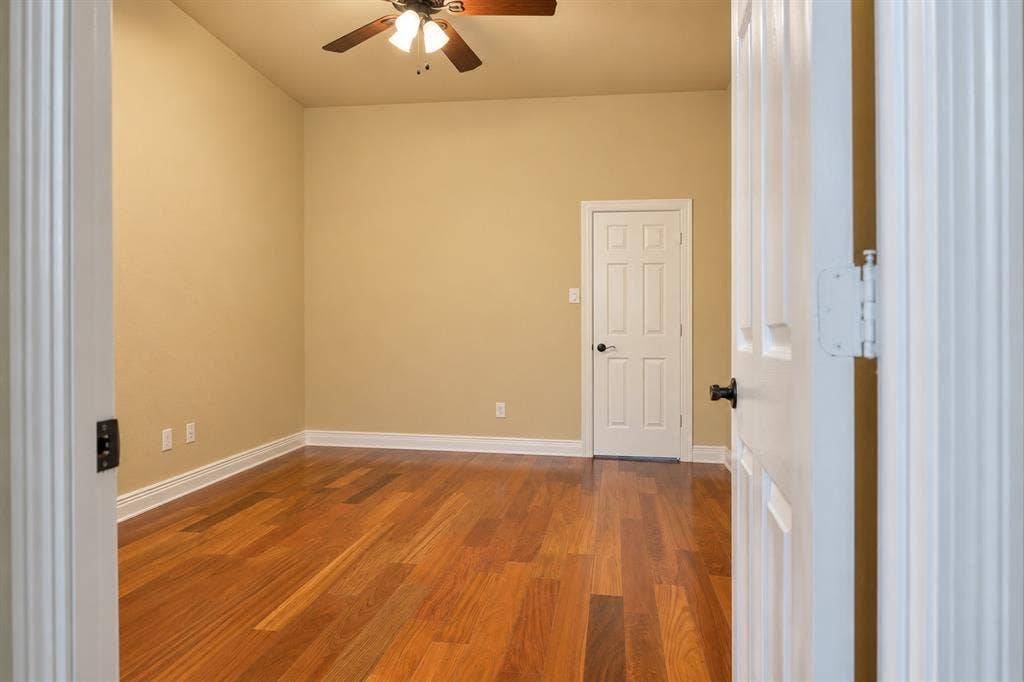 4505 Southgate Drive, Plano, TX 75024 Warm wood-finish flooring, neutral wall tones, and crown molding