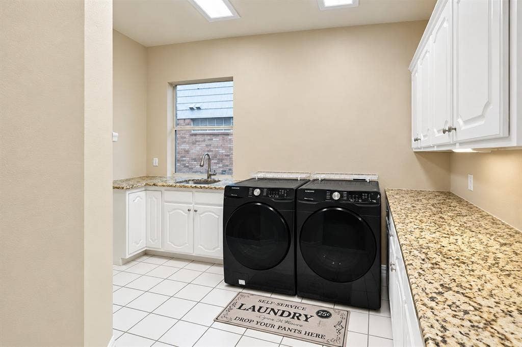 4505 Southgate Drive, Plano, TX 75024 White tile flooring, white cabinetry, granite-finish countertops, stainless steel sink with a gooseneck faucet, and recessed ceiling lighting