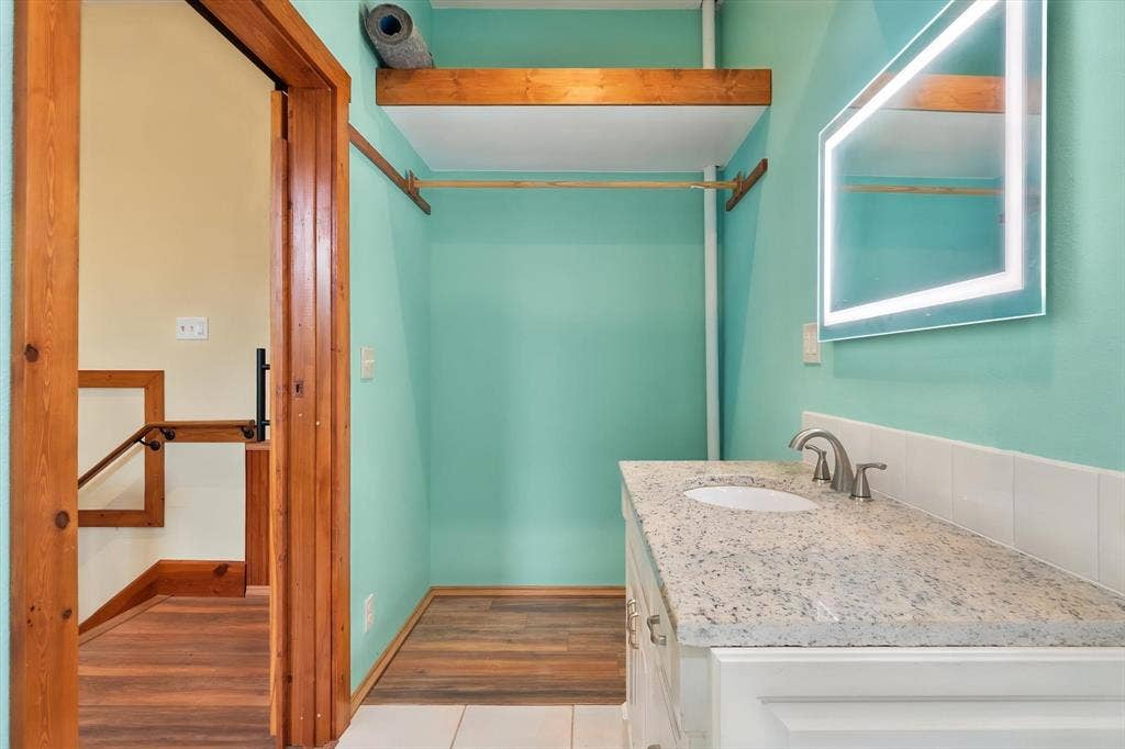 6472 Mark Drive, Burleson, TX 76028 Built-in vanity with a granite countertop, undermount sink, and brushed nickel faucet