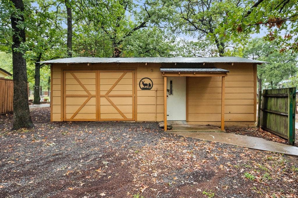6472 Mark Drive, Burleson, TX 76028 20x30 Corrugated metal roof, wood siding exterior, double barn doors, covered entry, and a side gate