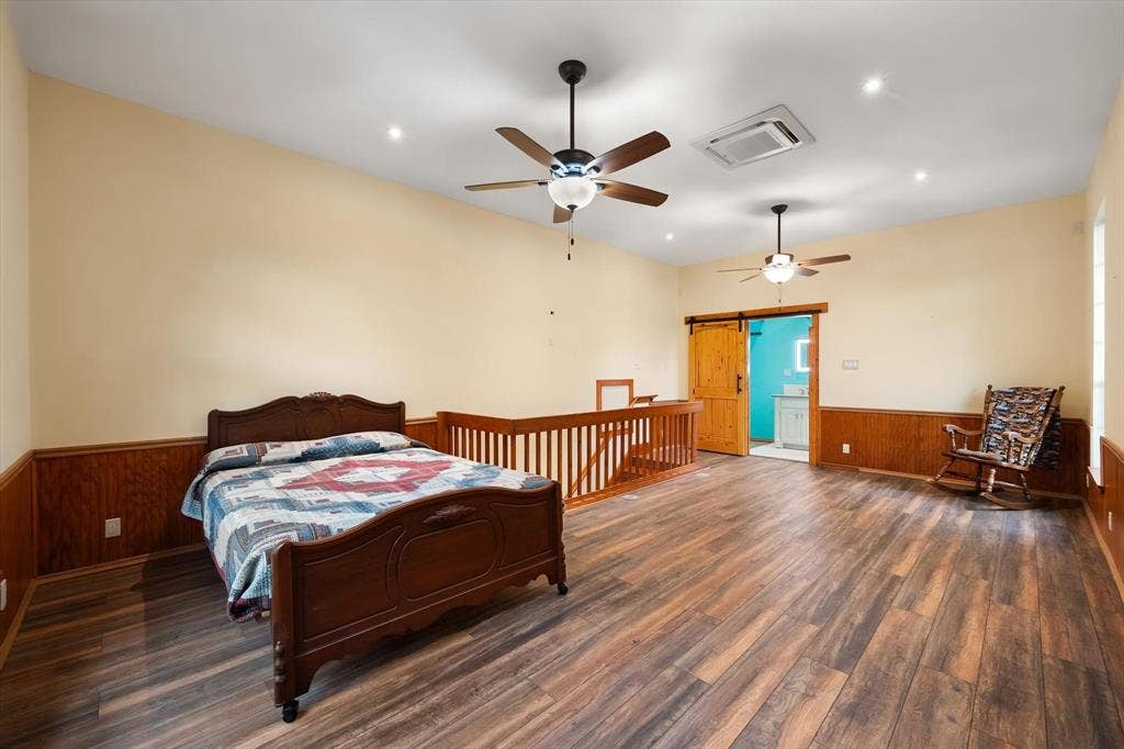 6472 Mark Drive, Burleson, TX 76028 Expansive room featuring wood-finish flooring, two ceiling fans, recessed lighting, and wood paneling