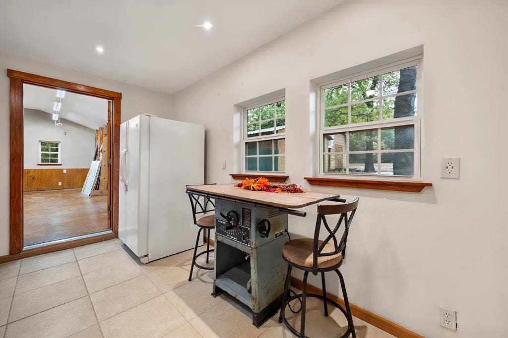 6472 Mark Drive, Burleson, TX 76028 Neutral-toned tile flooring, recessed ceiling lighting, a wood-trimmed doorway, and double-hung windows with wood sills