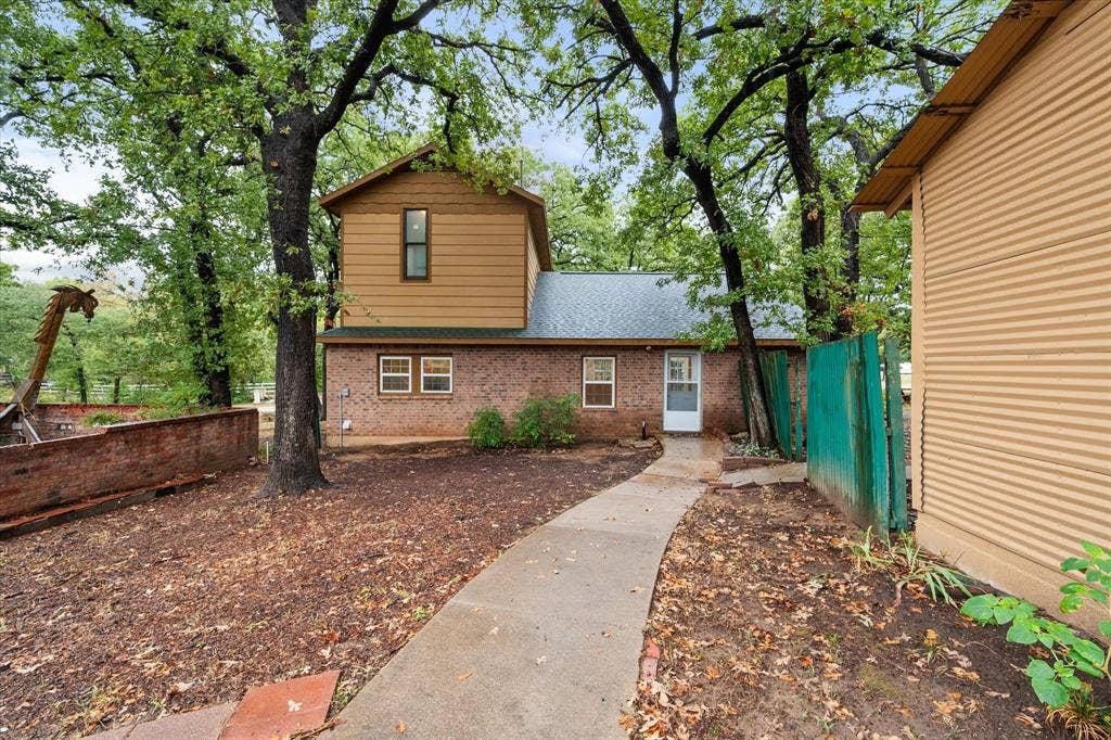 6472 Mark Drive, Burleson, TX 76028 Two-story residence featuring a brick first level and horizontal siding on the second story