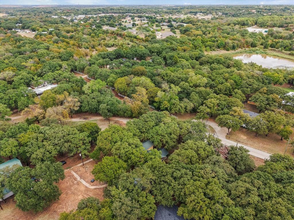 6472 Mark Drive, Burleson, TX 76028 Expansive treed landscape with a visible pond and paved roadways