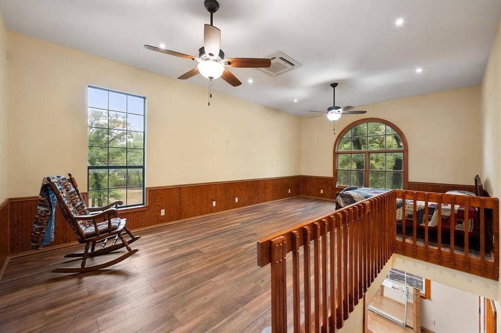 6472 Mark Drive, Burleson, TX 76028 Wood-finish flooring, wood paneling, recessed lighting, ceiling fans, and an arched window