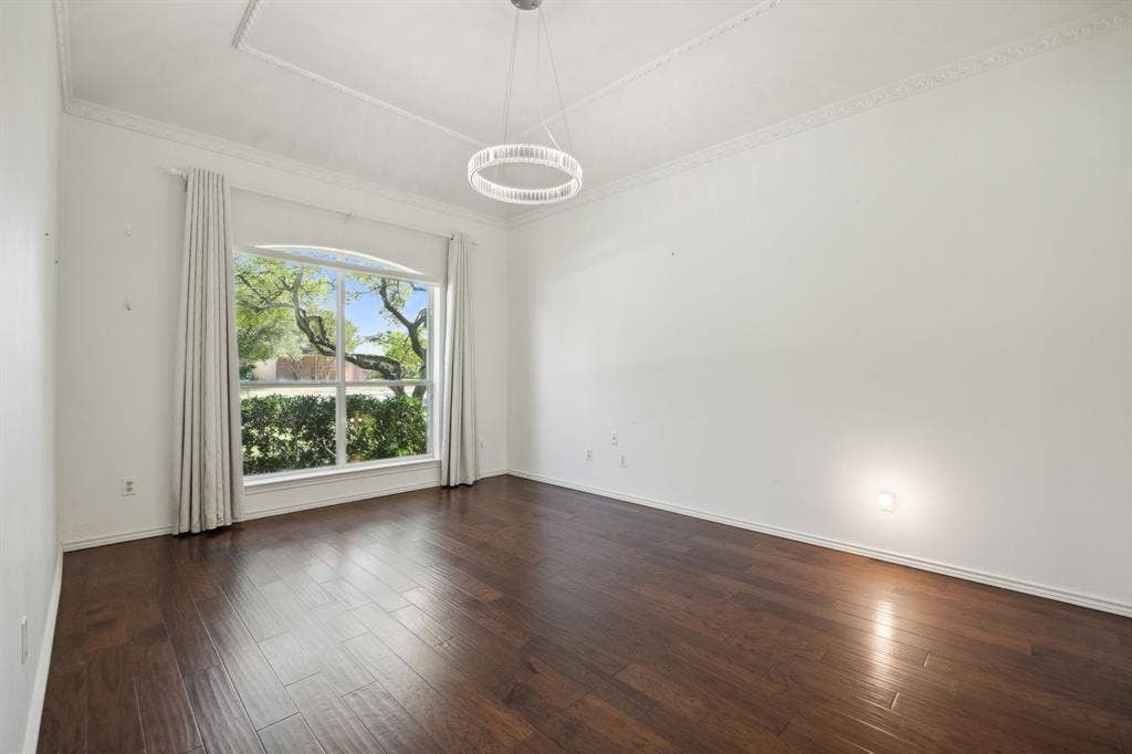 16353 Lauder Lane, Dallas, TX 75248 Hardwood flooring, crown molding, tray ceiling, contemporary chandelier, and large arched window